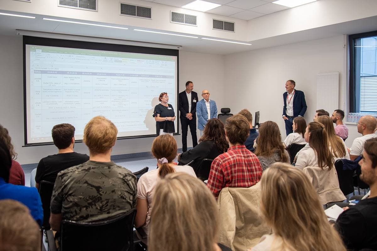 Program staff presenting a research schedule to a room of participants during a team briefing